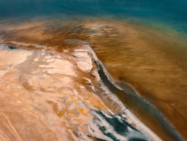 an aerial view of some water and sand