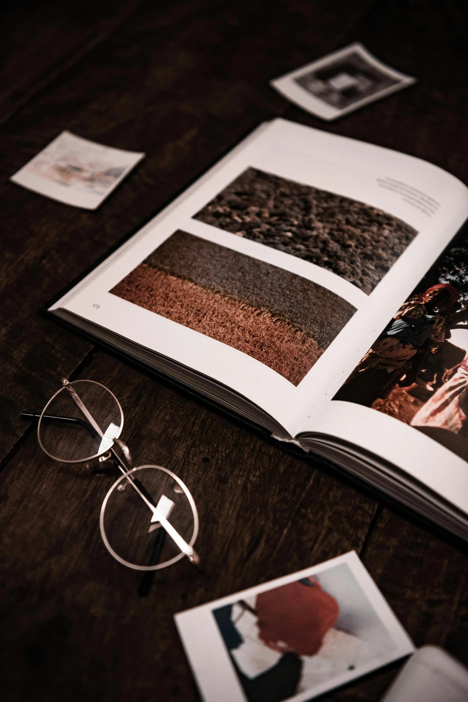 a book with some pictures and eye glasses on a table