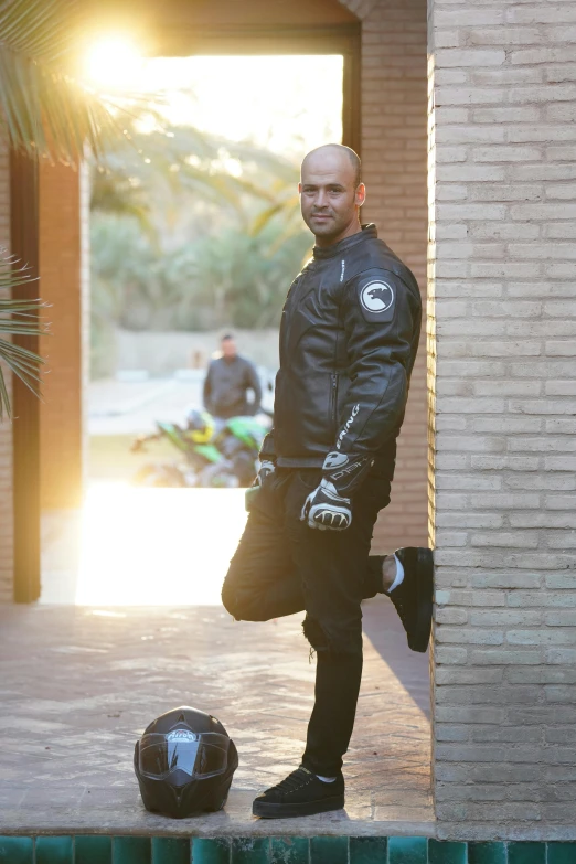 a man wearing a wet suit standing in front of a ball