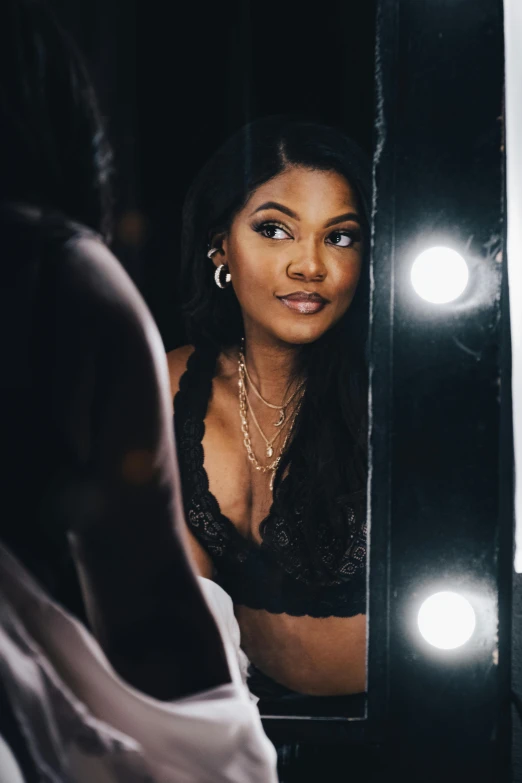 young african american woman looking into a mirror