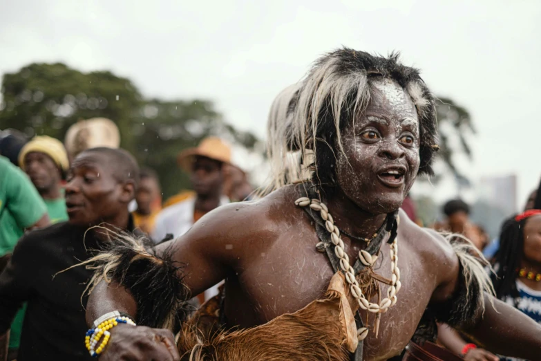 a group of men with different colored hair and dreadlocks in costume