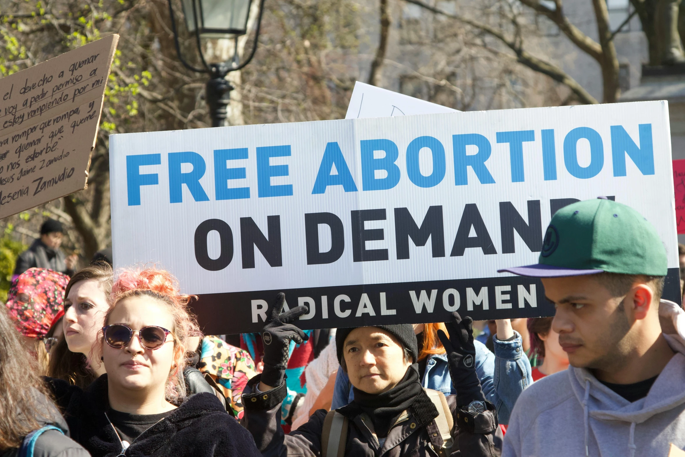 a man holds up a sign during an anti - labor march