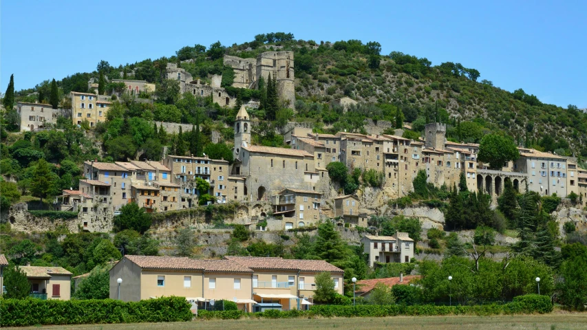 a cluster of abandoned buildings sit on the side of a mountain