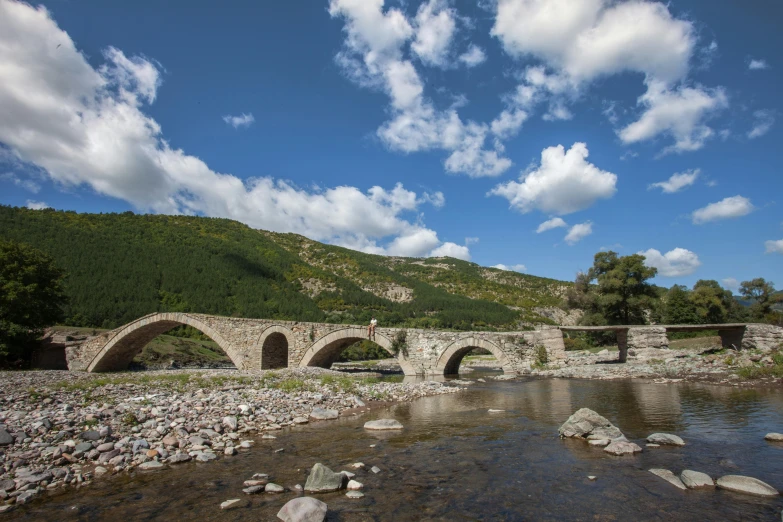 a bridge crossing over water in a valley