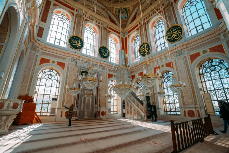 a large room with big chandeliers and windows