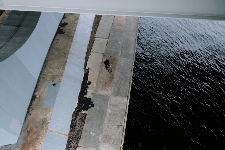 an image of a walkway over water with a reflection on the ground