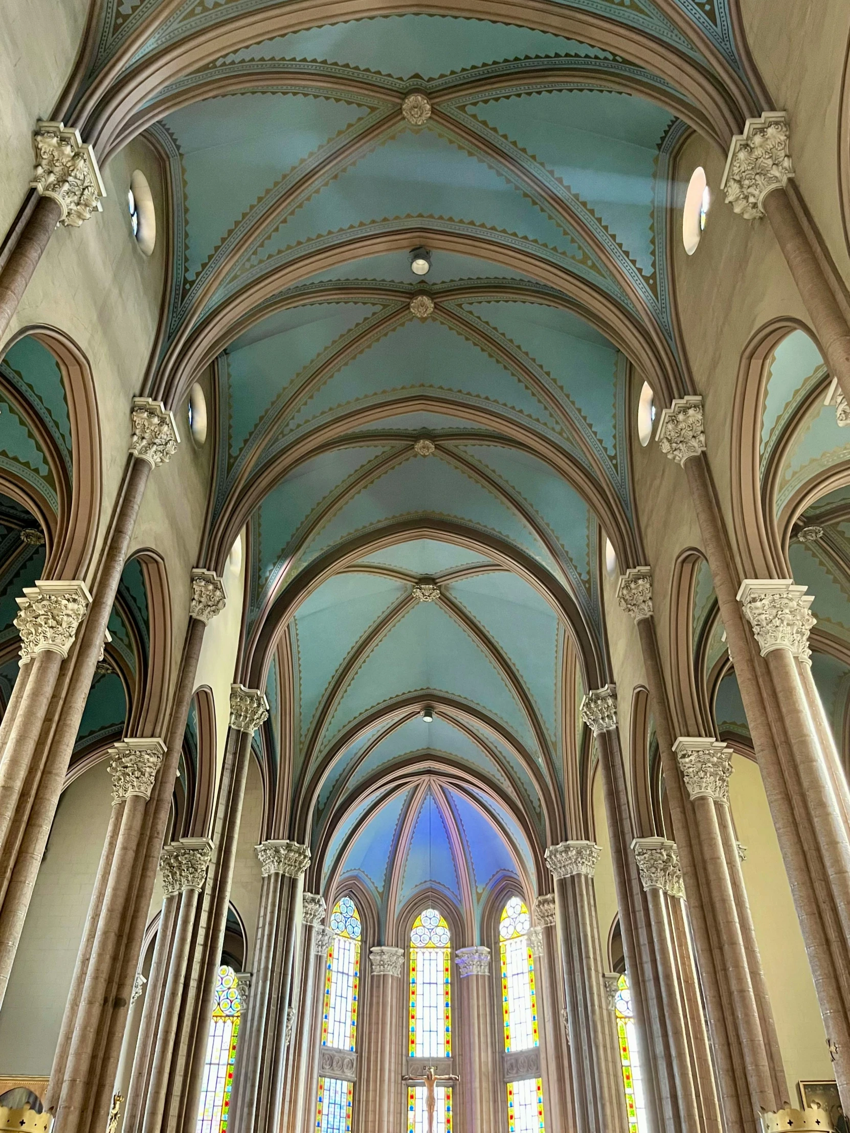 the interior of a cathedral has multiple windows and arches