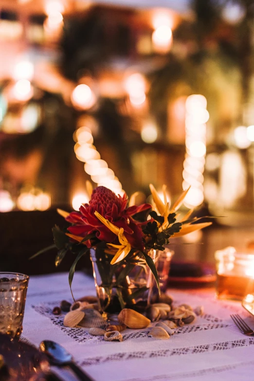 a table set with candles and vases and some plates