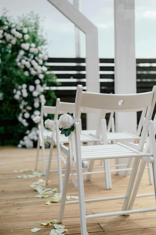 a row of empty chairs sitting on top of a wooden floor