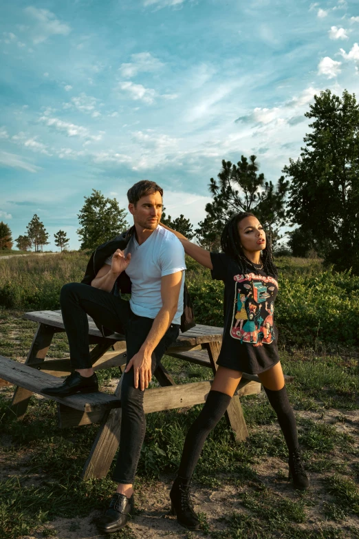 a man and woman sitting on top of a wooden bench