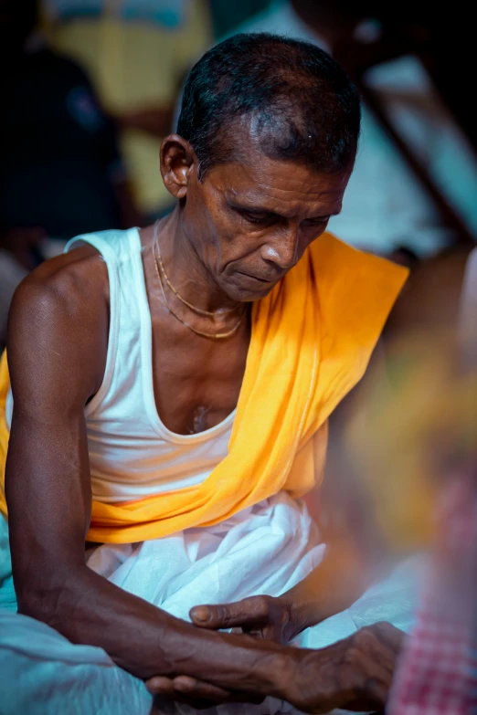 an elderly woman sitting and writing in her lap