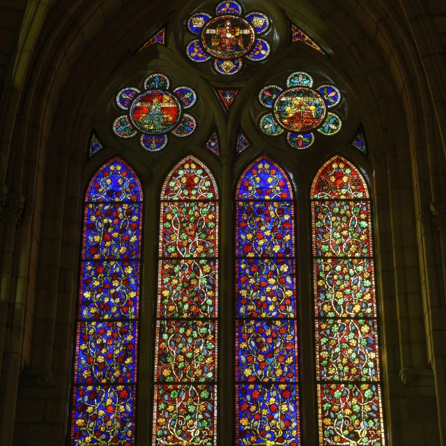 a window is adorned with many colored glass