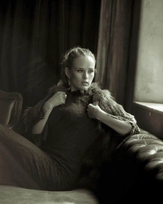 woman holding stuffed animal while sitting on couch