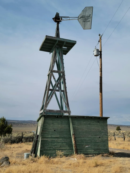 an old fashioned windmill sits in a field