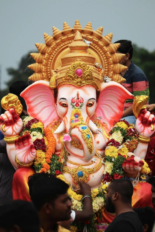 a man taking a po with an elephant mask