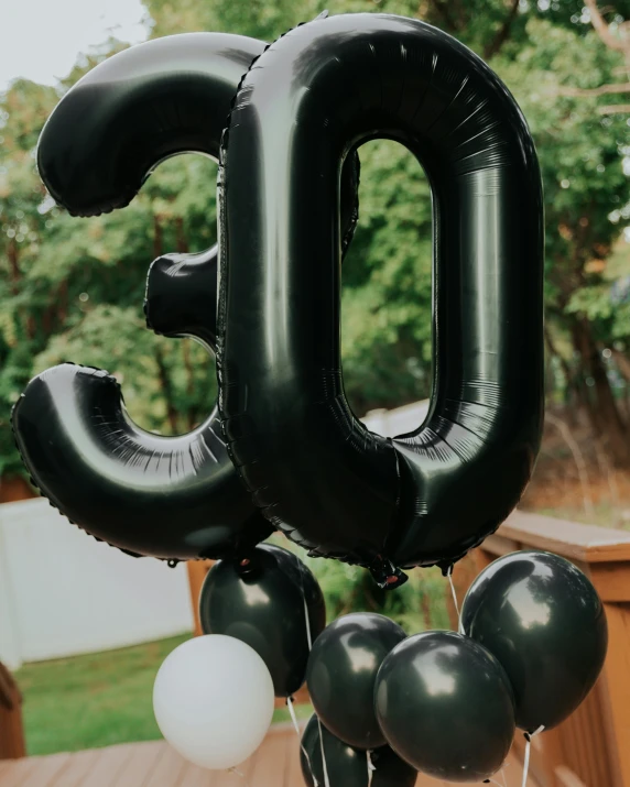 some black balloons with the number fifty on them