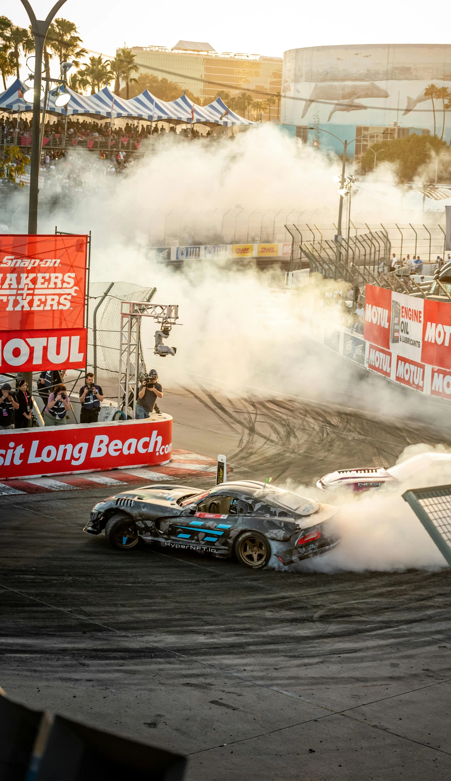 two cars are driving on a dirt track