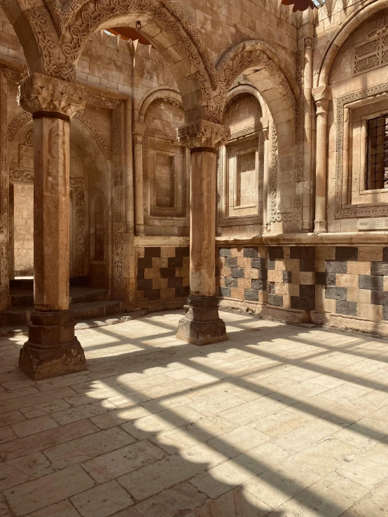 a stone building with columns and tile floors