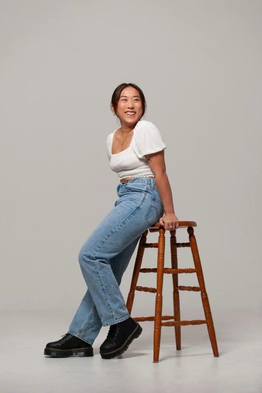 a person sitting on top of a stool