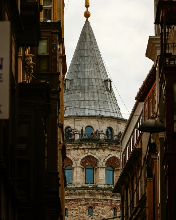 a tall building with a clock on it's face near many other buildings