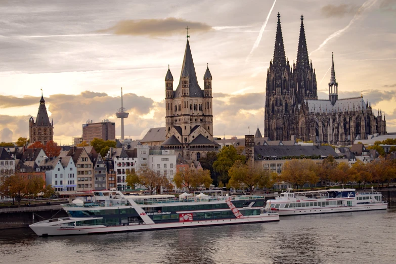 three ferry boats are docked in front of an old city