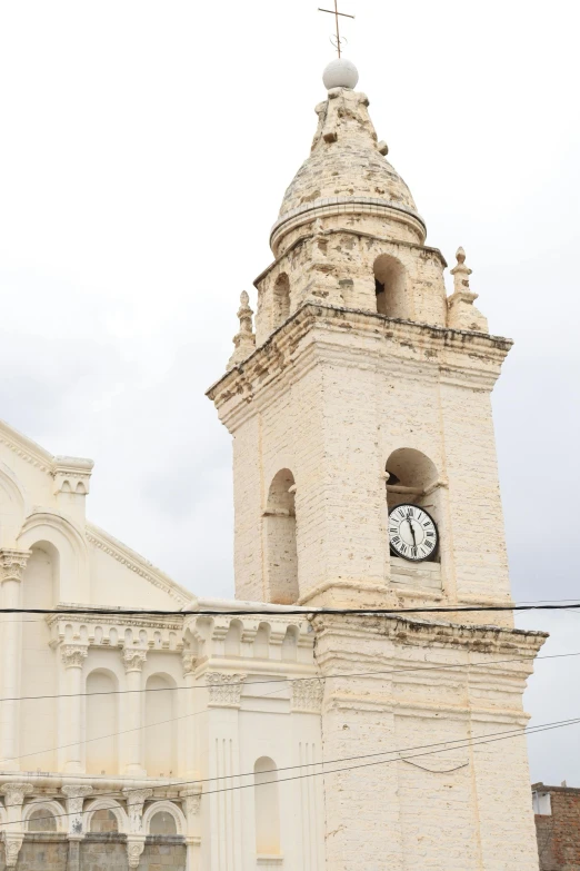 a large church steeple with a white clock