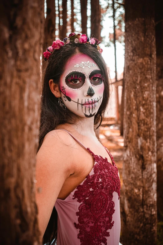 young woman wearing skeleton make up in an autumn forest