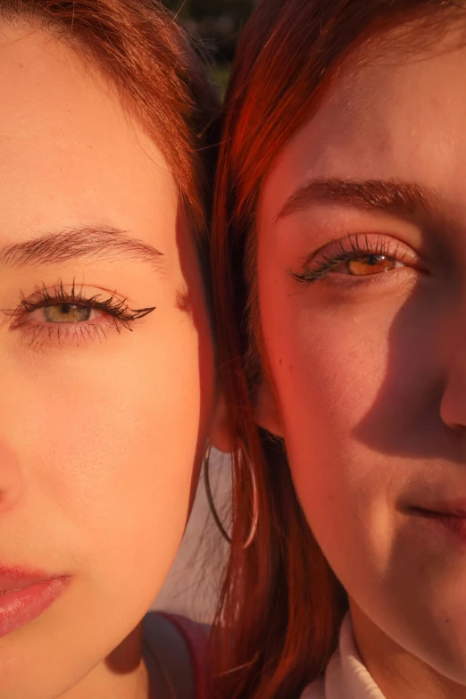 a closeup po of two people one with green eyes and red hair