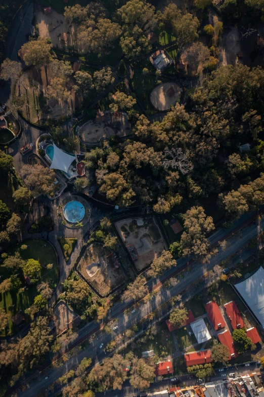 an aerial view of a city with a park in the distance