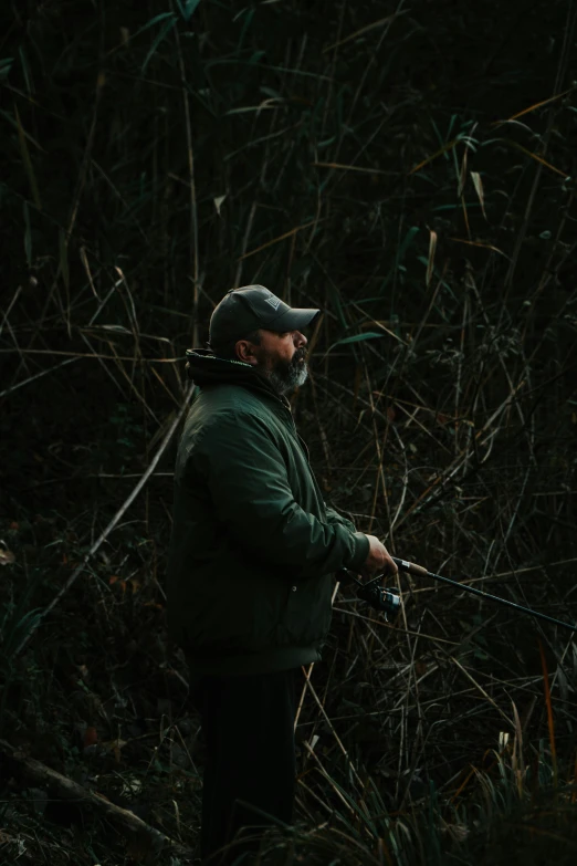 an older man with a gun is looking at some sticks