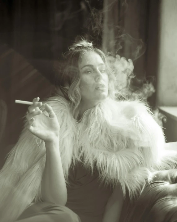 a woman smoking on a couch in the dark