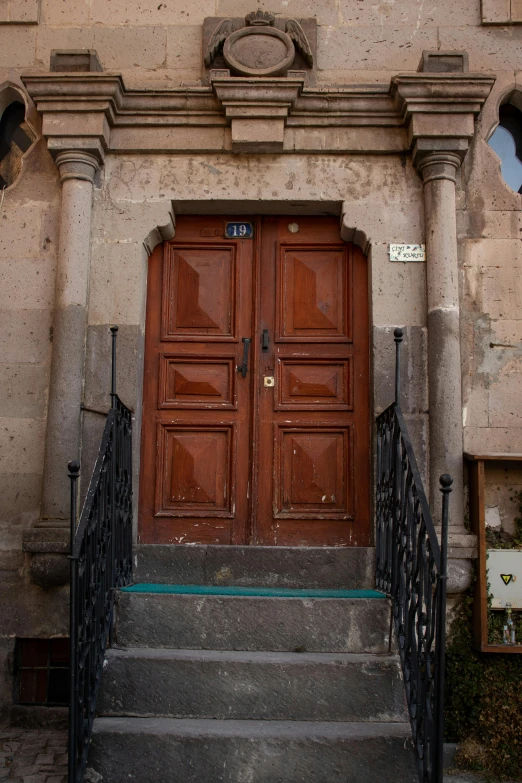 an old building with a very big wood door