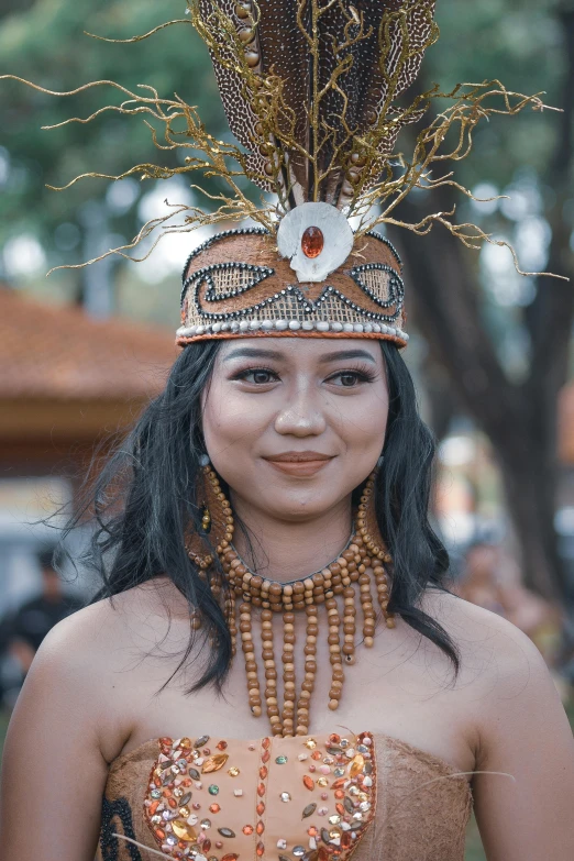 a women with an elaborate head dress and large feathers