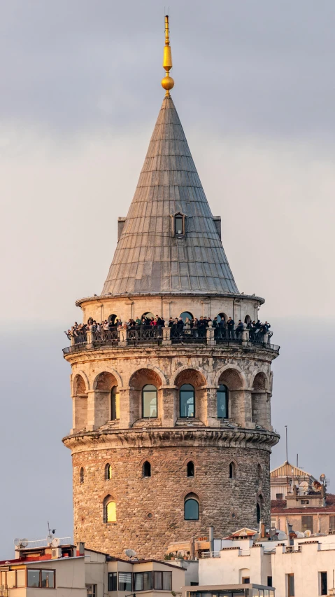 a building has a tower and people are standing on top of it