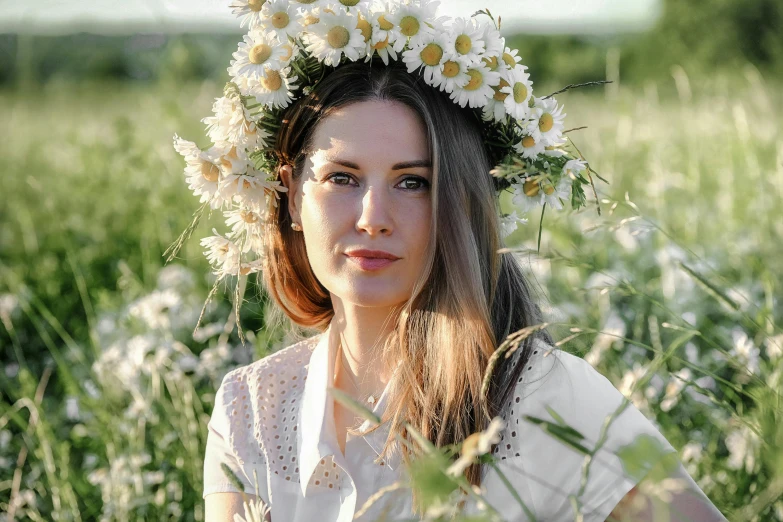 a woman in a field with flowers in her hair