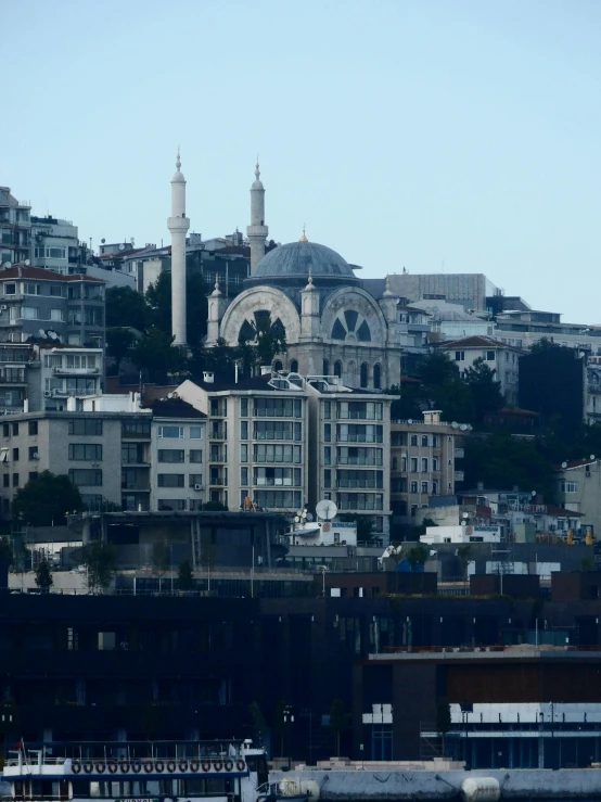 a city with many tall buildings in front of a blue sky