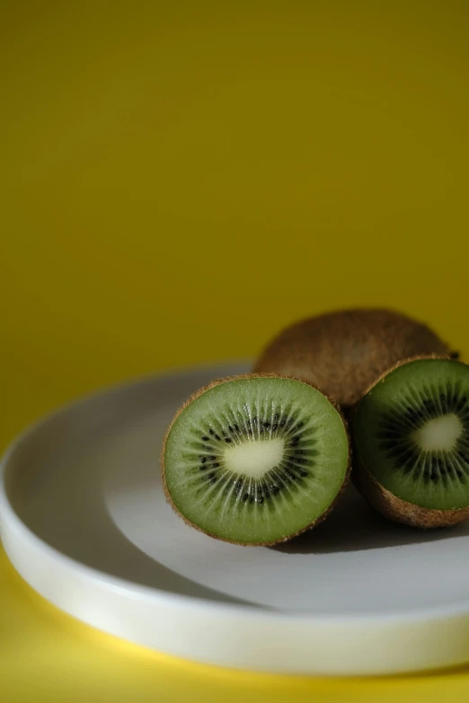 a kiwi fruit sitting on a plate