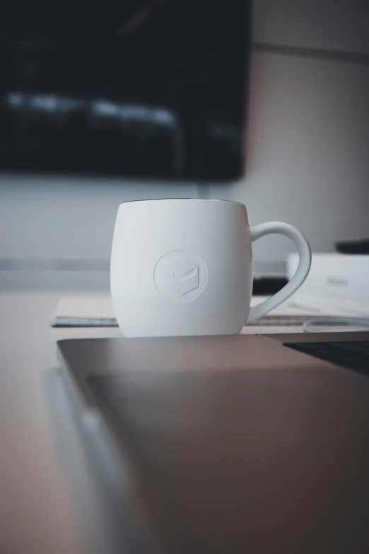 there is a mug sitting on the desk