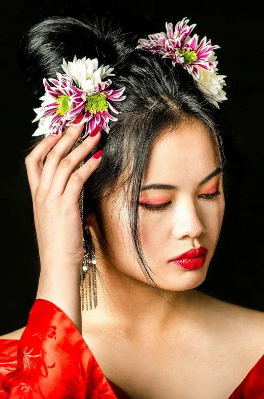 a woman in a red dress with two flowers in her hair