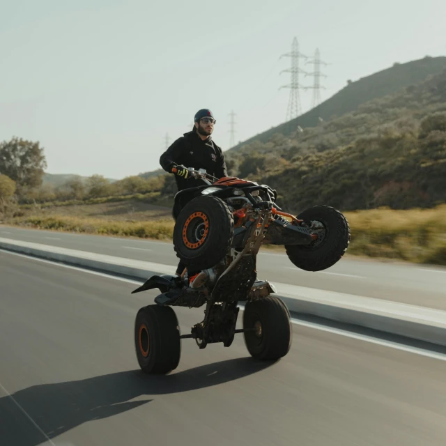 a man is riding on a large atv