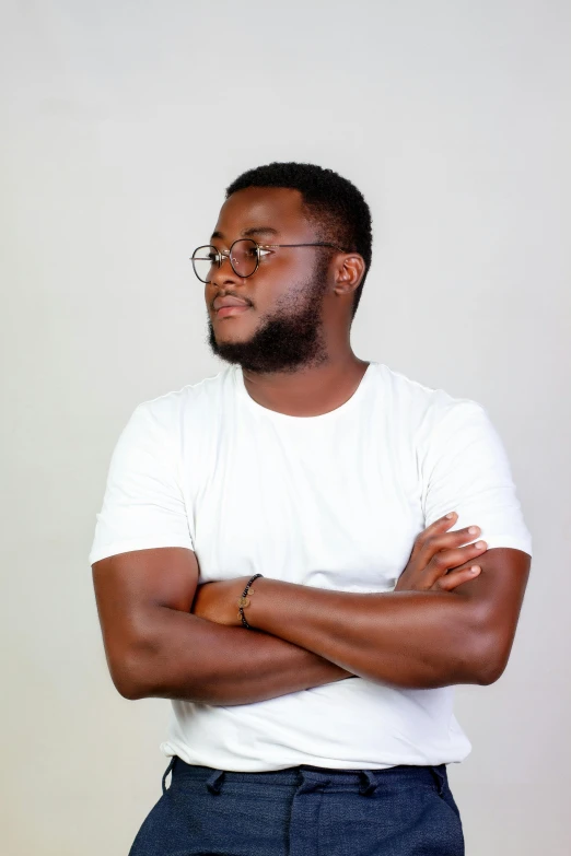 a black man with glasses and a white tee shirt