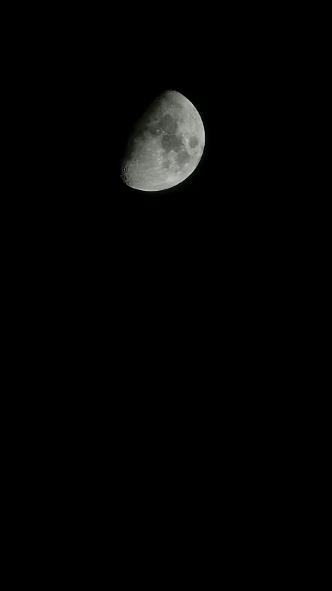 a white airplane flying in the air next to the moon