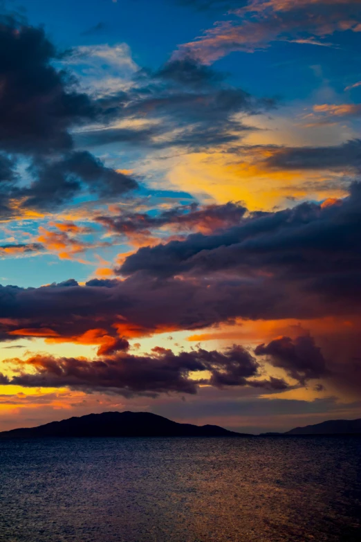 a sunset on the beach next to water