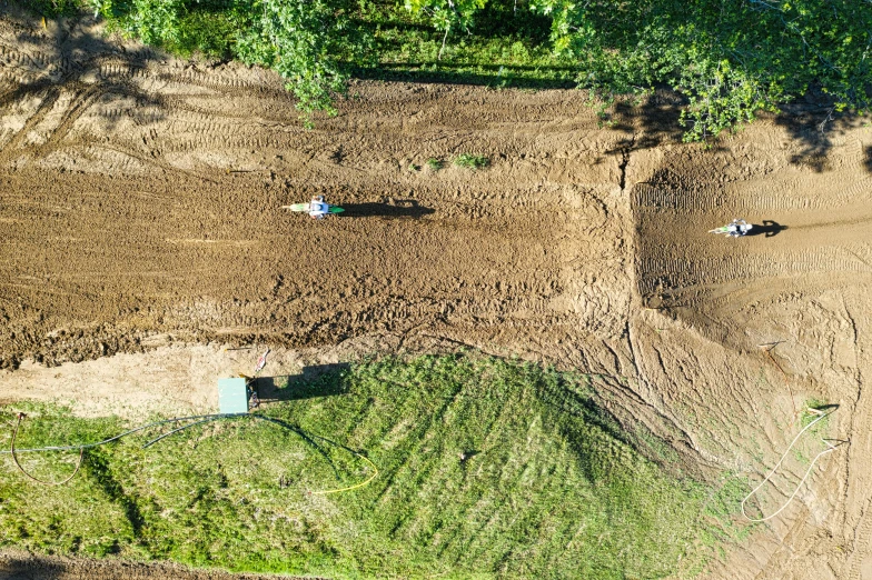 farm work in the middle of an area with dirt and grass