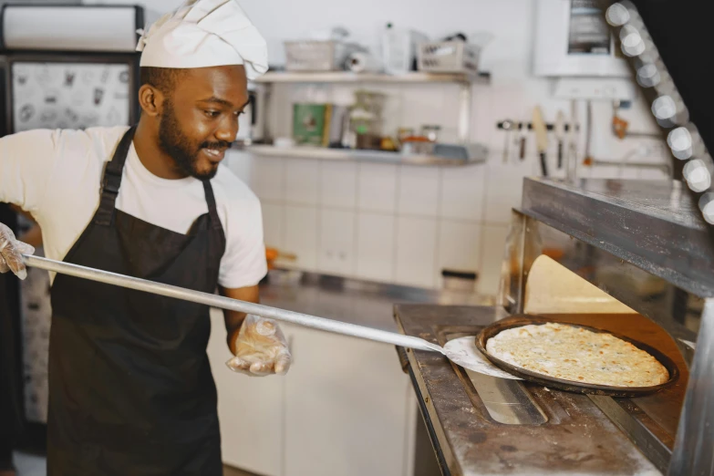 man cooking food in a professional kitchen at the local restaurant