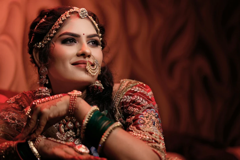 a woman wearing an indian bridal outfit