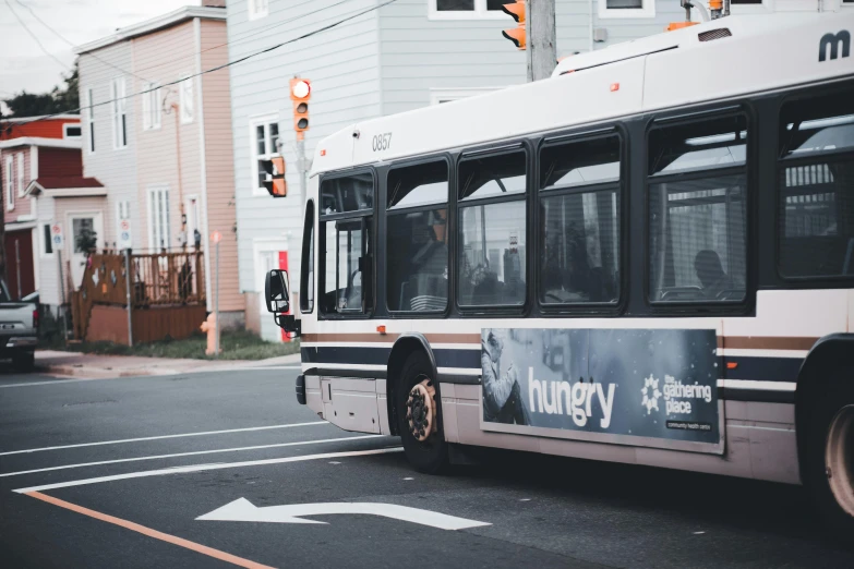 a bus is stopped in the street with a large advertit on it's side