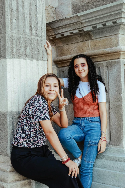 two teenage girls posing in the roman numerals
