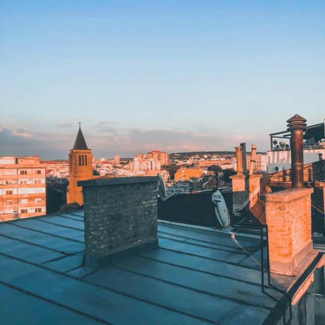 a city skyline with tall buildings next to a metal roof