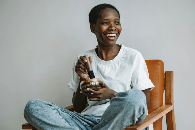 the woman is sitting down holding a bottle of wine